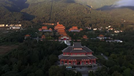 Chongsheng-Temple-on-Mount-Cangshan-hillside,-sunset-aerial-view