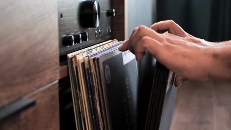 close up man hands browsing vintage vinyl records