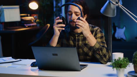 freelancer listening music while doing computer tasks in home office