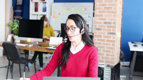 woman in headset working in an office call center