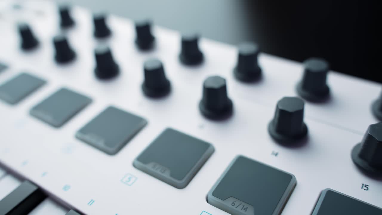 Close-up macro of a white MIDI controller showing drum pads and rotary knobs. Clean studio tech vibe with soft lighting and shallow depth of field