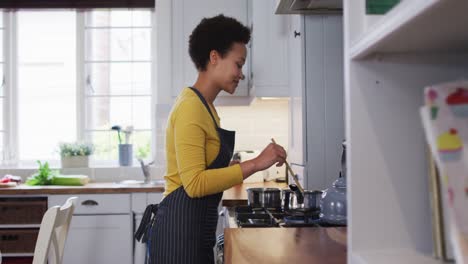 mixed race woman preparing food in kitchen