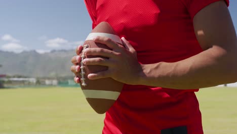 american football player holding a ball