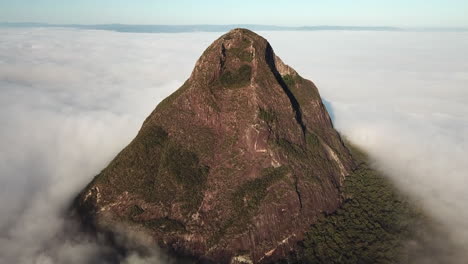 Drone-flying-above-Glass-House-Mountains-on-a-foggy-sunrise-,-Far-North-Queensland-Australia