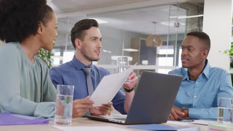 happy diverse business people discussing work and using laptop at office, slow motion