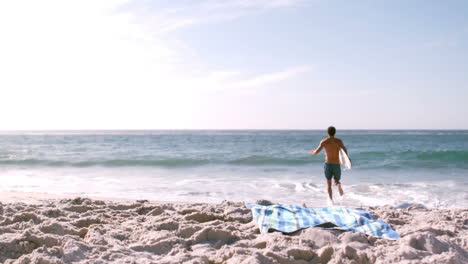 A-man-is-running-with-his-surfboard-