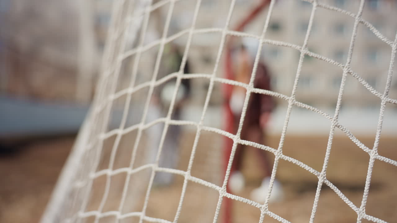 closeup of soccer net, detailed mesh and goal structure, sharp focus on net fibers and textures, clear image showing sports field tension and intricate net details