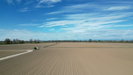 drone flies quickly over freshly cultivated fields in the po valley on a sunny spring day