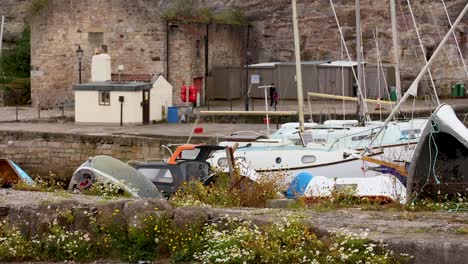 boats and harbor buildings in fife, scotland