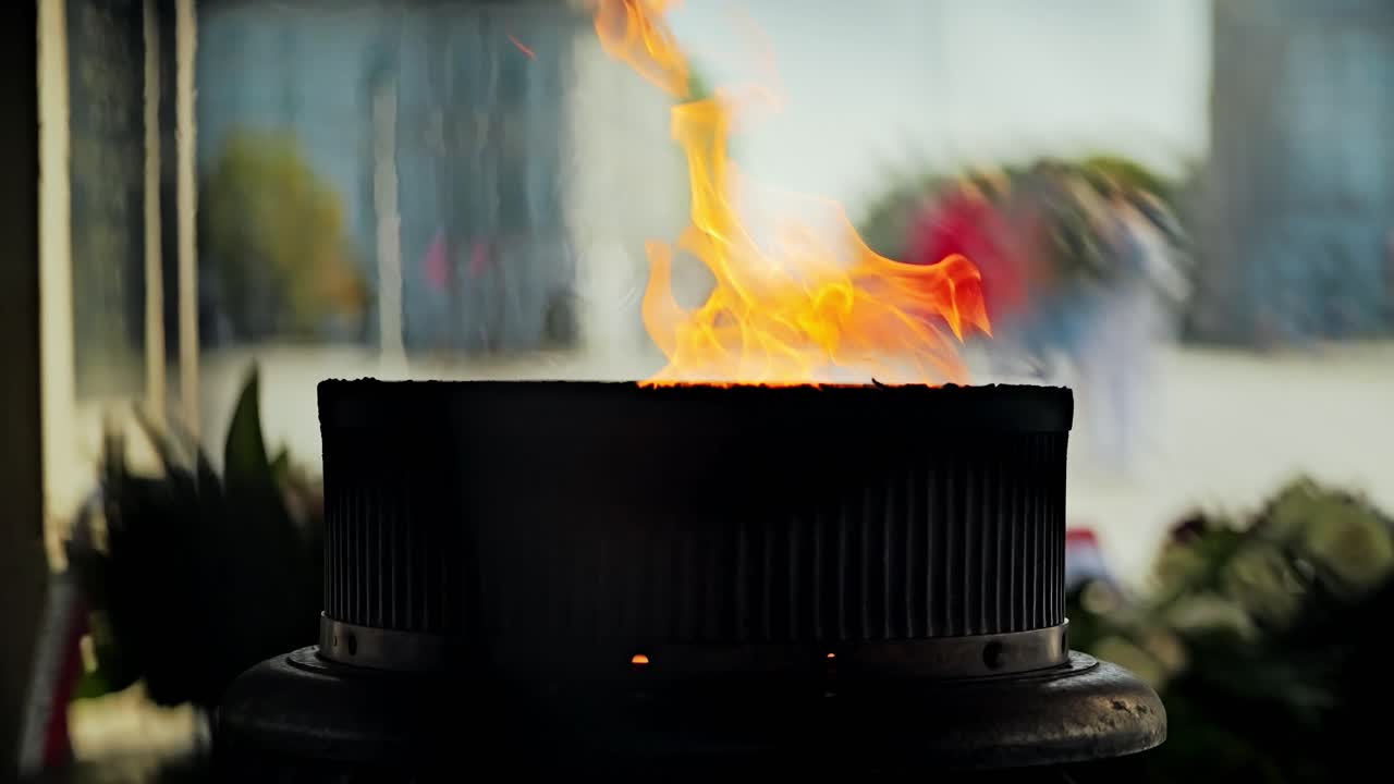 Gentle fire moves in slow motion, symbolizing sacrifice, silence and memory