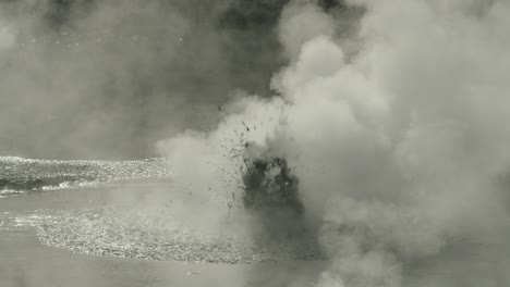 boiling hot geothermal volcanic mud pool, closeup shot steamy lake bubbling mud and steam