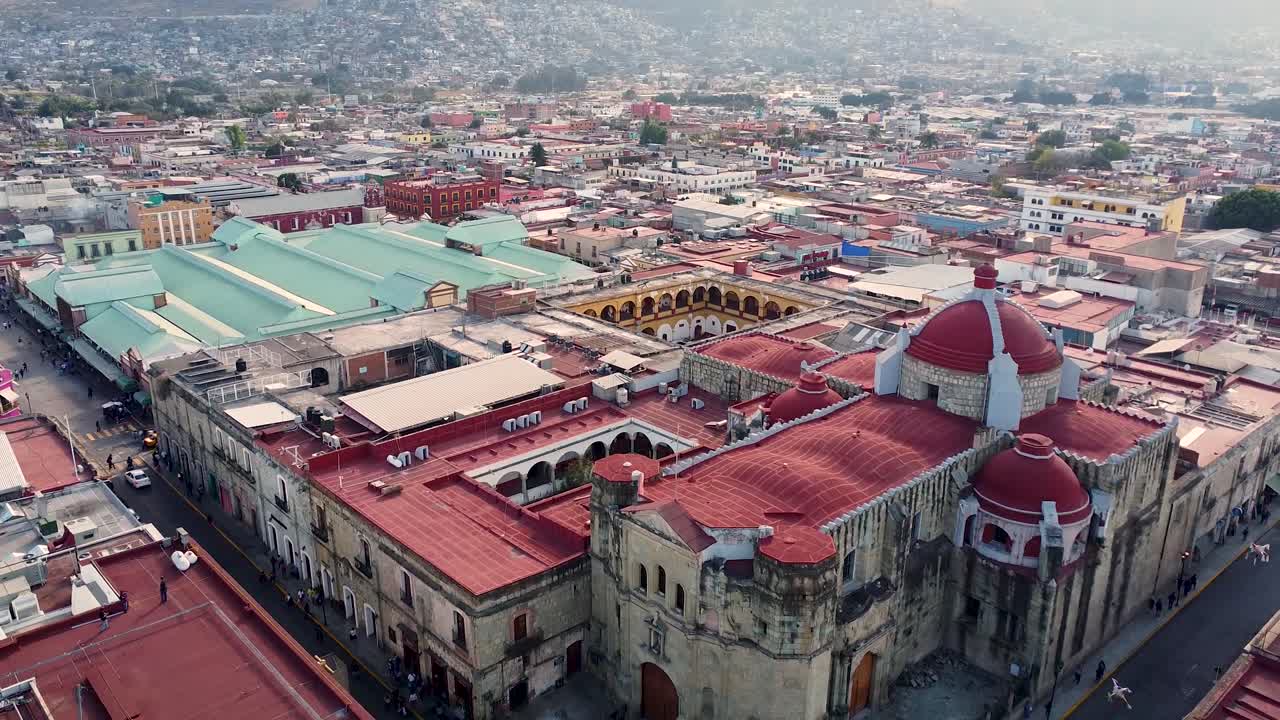 Ripresa aerea che sorvola una chiesa dalla cupola rossa e la città a Oaxaca de Juarez - Messico