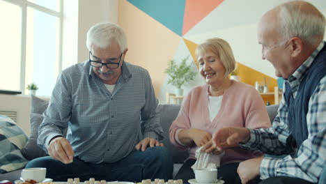 elderly friends enjoying a board game