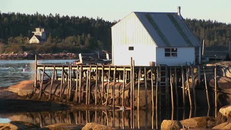 a small lobster village building in stonington maine is on a rock island and pier 2