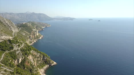 croatian coastline covered with rocks and trees with beautiful blue water and skies during a sunny day