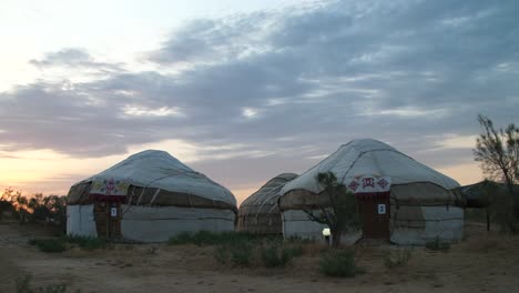 yurts in desert at dusk