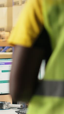 vertical video storage room employee scanning shipping labels to register in inventory