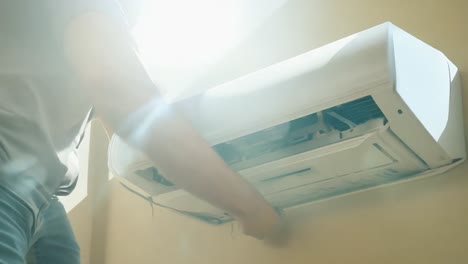 man repairing an air conditioner unit