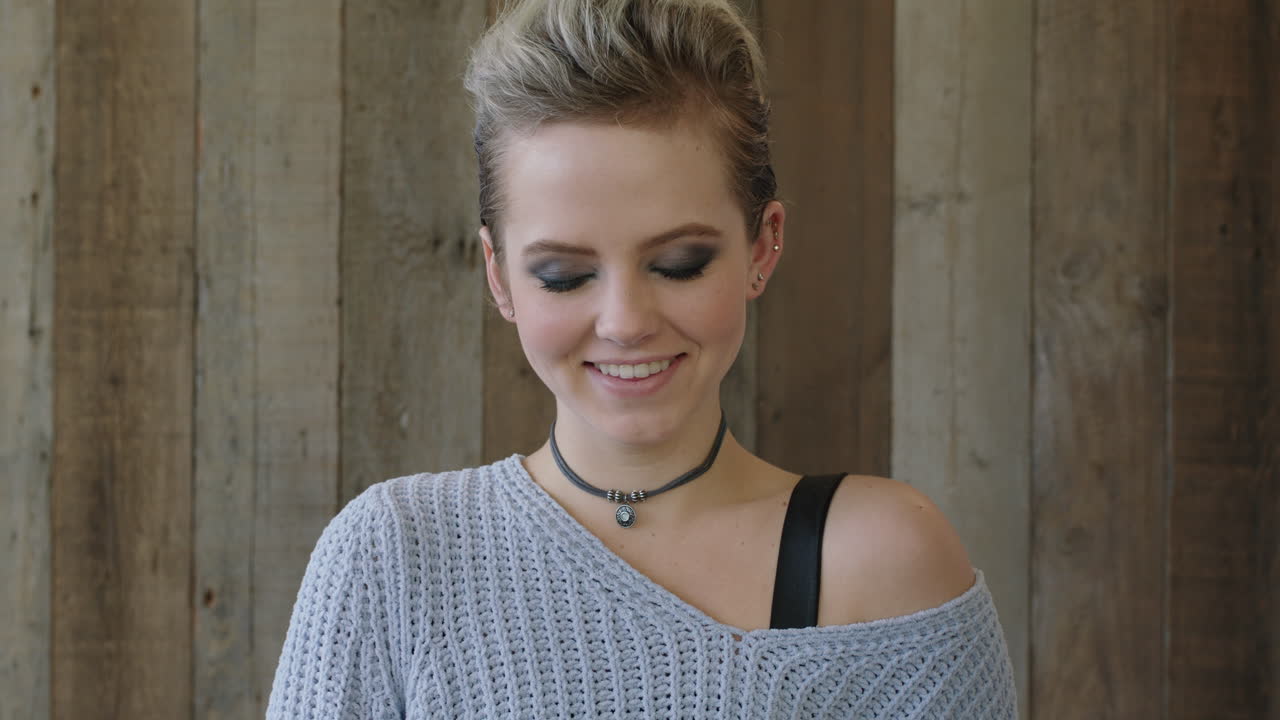 close up portrait of cute young woman smiling vulnerable shy looking at camera wearing stylish fashion