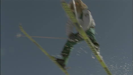 a skier jumps from the edge of a snow ridge