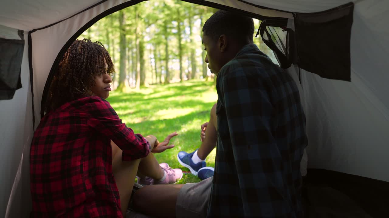 Young couple camping in the forest