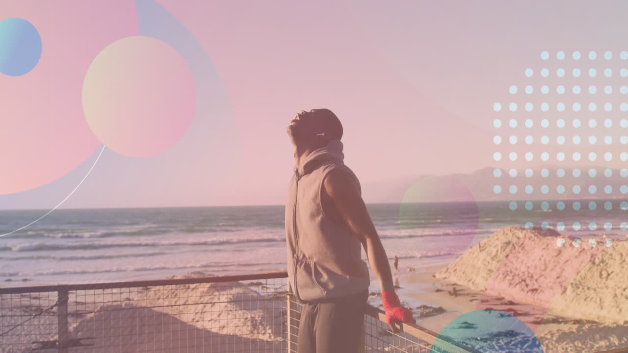 해변에서  ⁇ 어있는 아프리카계 미국인 남성 위의 모양의 애니메이션