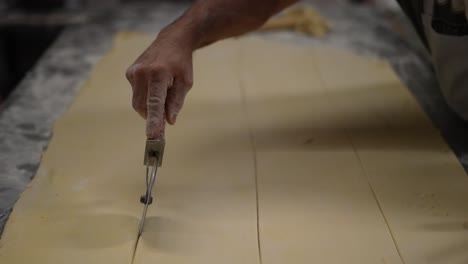 wheel-cutter,-artisan-bakery,-baker-making-bread-and-pastry,-dough-kneading