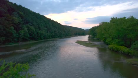 beautiful water reflection as the drone aerial float over the water at sunset of the susquehanna river in pennsylvania