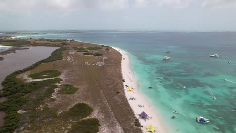 Water-Sport-enthusiasts-enjoying-the-clear-blue-water-at-Crasqui-Island,-Los-Roques