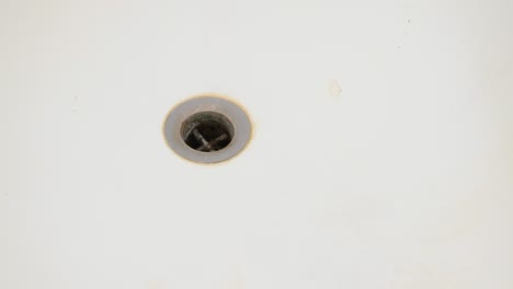 clogged dirty bathtub drain sinkhole. slider and panning shot, top view, real time, no people