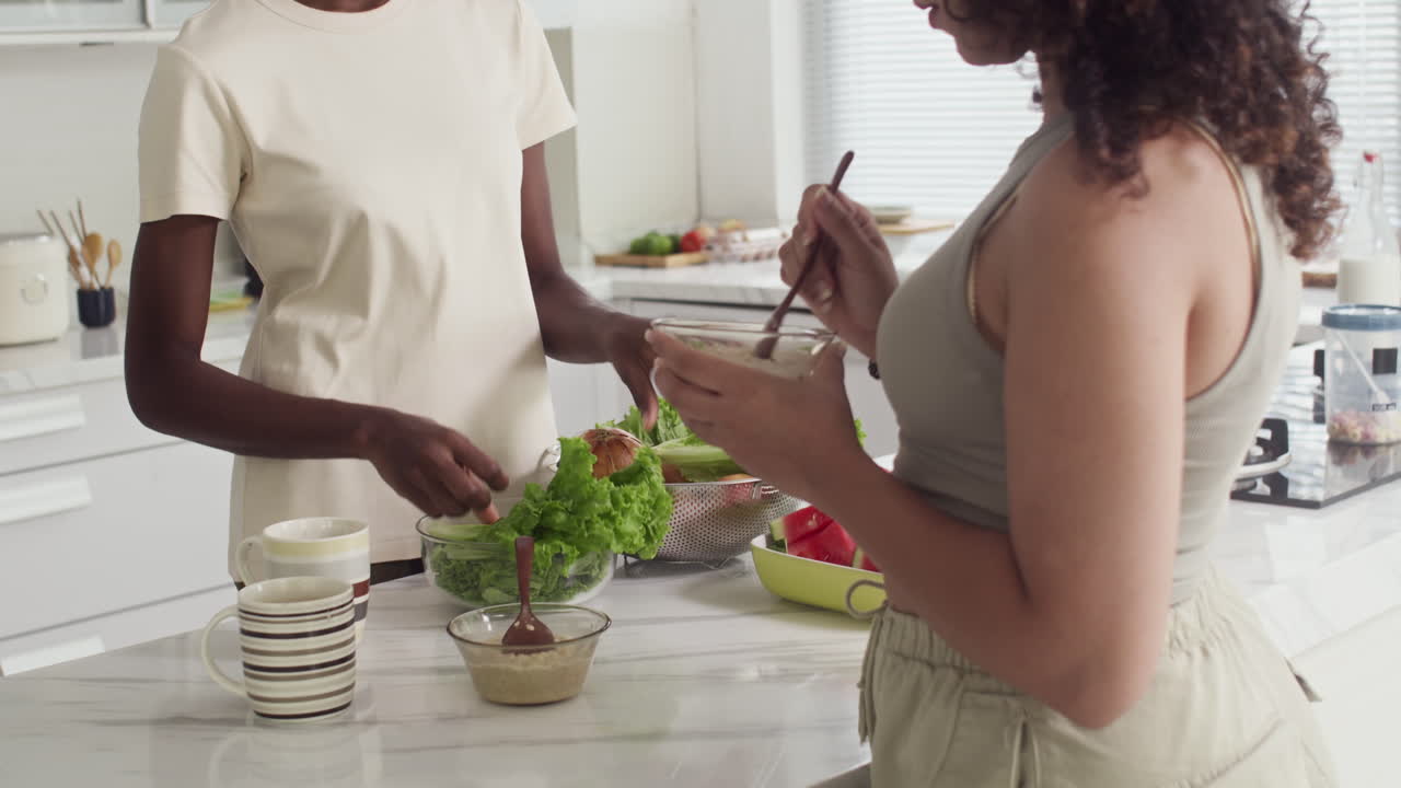 Roommates Talking while Having Breakfast at Kitchen