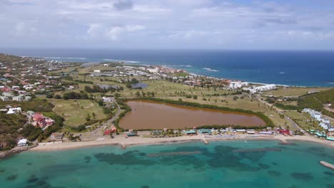 aerial view overlooking the famous frigate bay beach in saint kitts and nevis - pan, drone shot