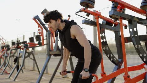 man doing push-ups on outdoor gym equipment