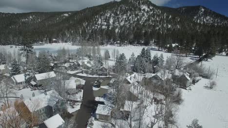 an aerial over a snow covered village in the mountains