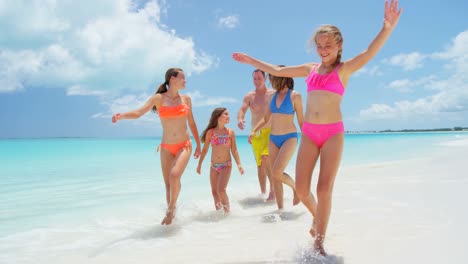 caucasian family in swimwear on tropical beach vacation