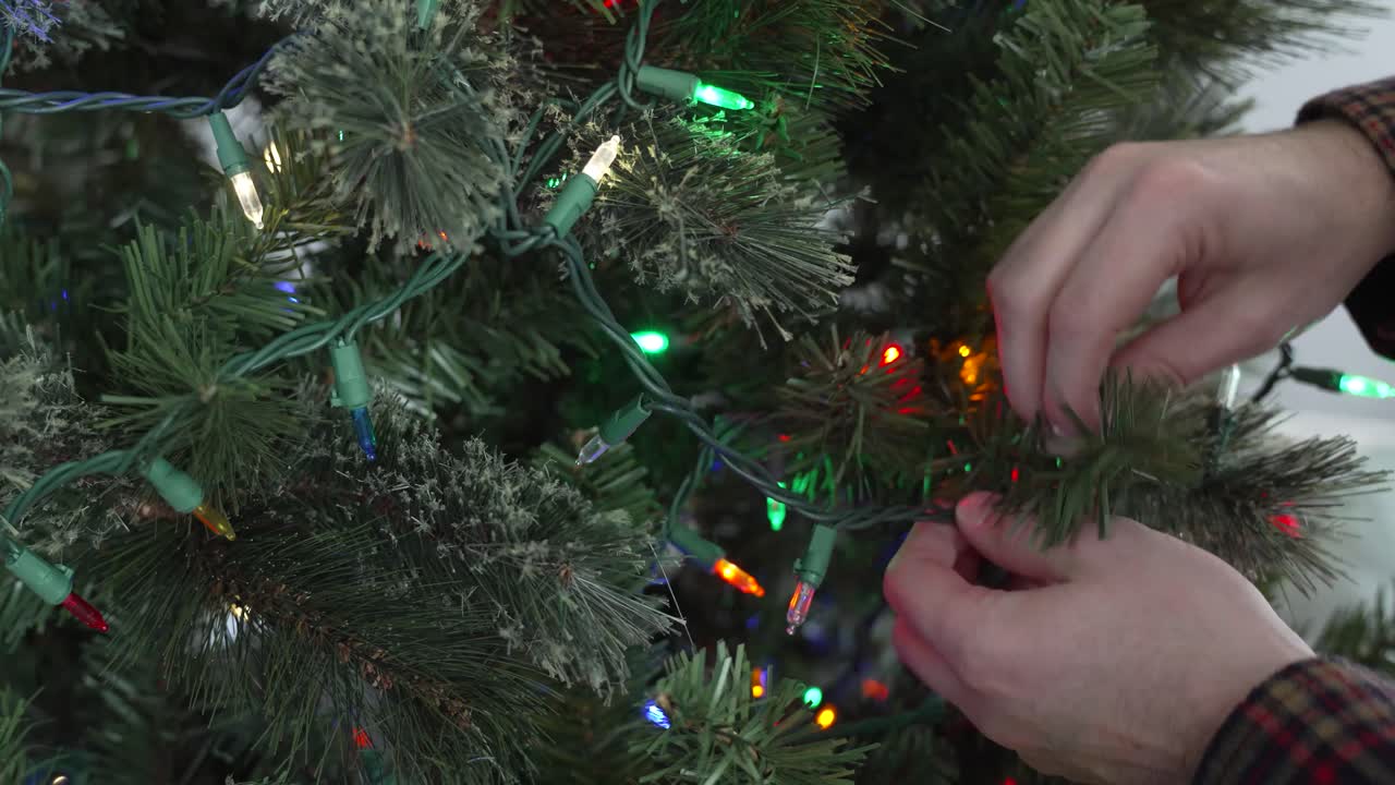 Hanging Christmas lights on a Christmas tree