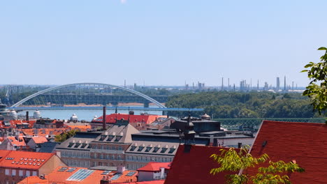orange roofs of the buildings in the old town of bratislava, slovakia. new city and the appolo bridge at backdrop