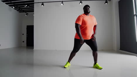 man dancing and stretching in studio