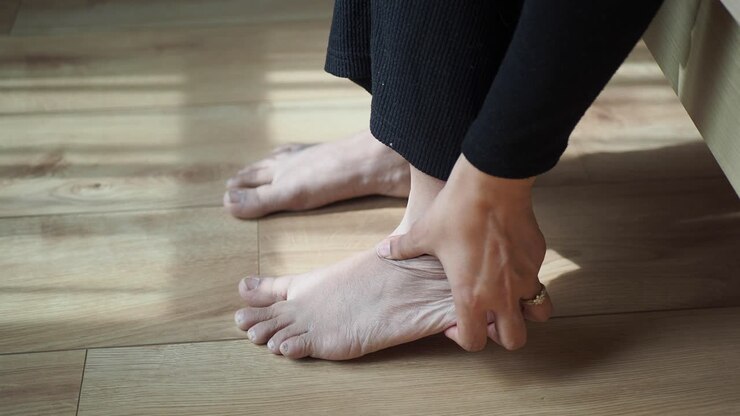 Woman holding her sore foot