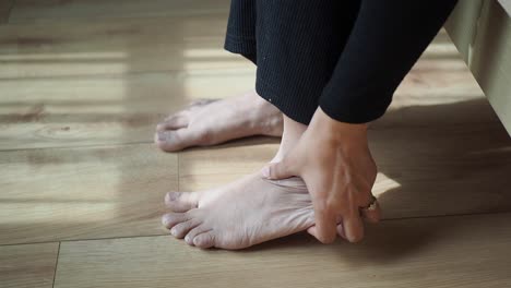 woman holding her sore foot