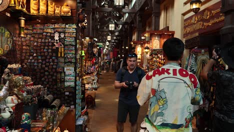 two people browsing an antique souvenir shop