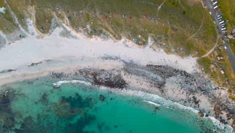 aerial view above beach and transparent, arctic sea, in norway - birdseye, drone shot, uttakleiv beach