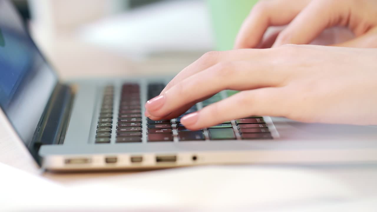 Woman hands working on laptop computer. Worker typing on a keyboard
