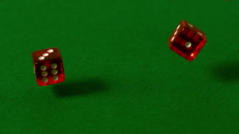 red dice falling on casino table