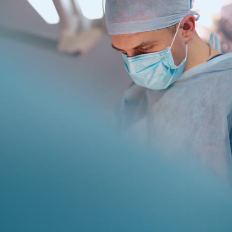portrait of a surgeon performs a surgery with instruments. medical workers in uniform performing operation. surgery operation concept.