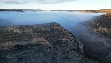 Cloud-Cover-in-Mountain-Valley-in-Albarracin,-Teruel,-Aragon,-Spain---Aerial-4k