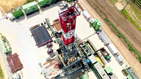 oil and gas onshore drilling rig in austria during summer - aerial drone shot