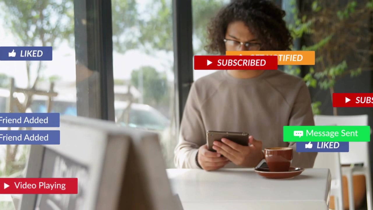 Vertical video: Man checking tablet at cafe, focus shifting causing social media badges over him