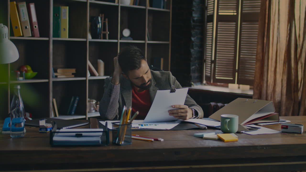 Exhausted man solving business problem. Office worker lies on table