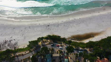 Aerial-view-of-traffic-on-a-coastal-road-in-Carmel-by-the-sea,-sunny-Monterey,-CA